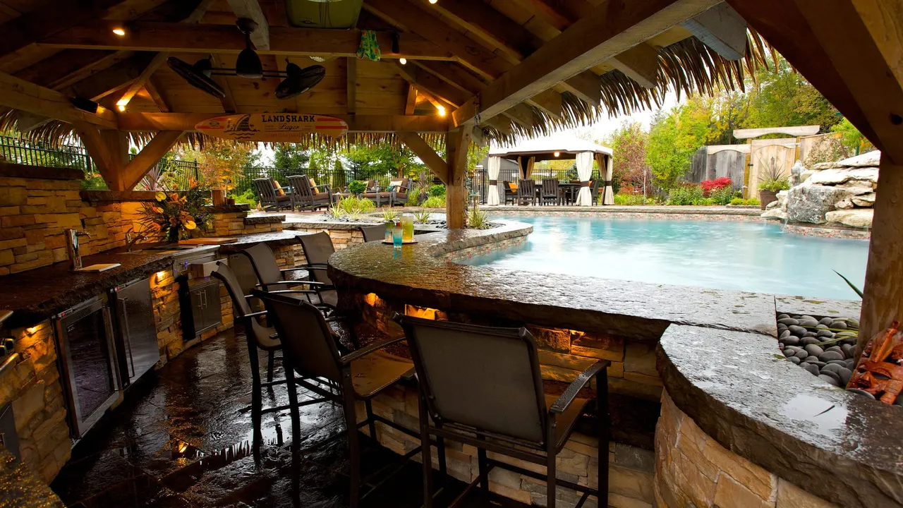 Illuminated swim-up bar with landscape lighting
